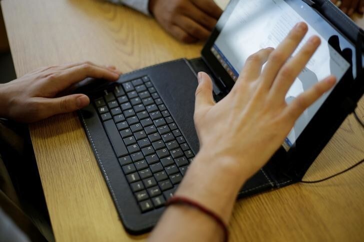 A man works on his computer at a coffee shop in Ciudad Juarez, October 19, 2017. Picture taken October 19, 2017. REUTERS/Jose Luis Gonzalez