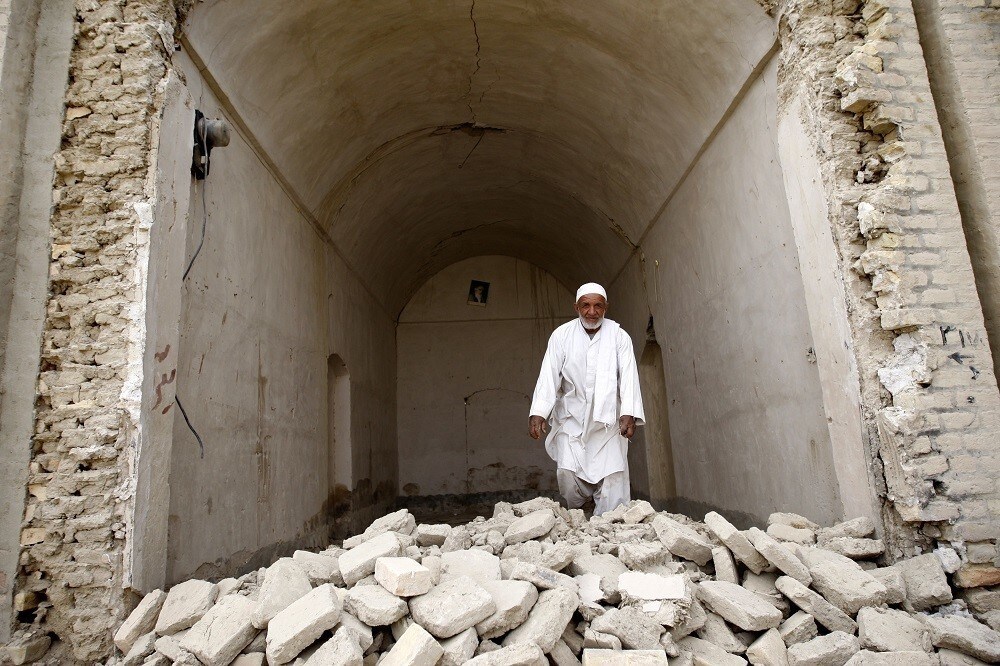 A man walks at his shop after an earthquake in Saravan, about 1,400 km (869 miles) southeast of Tehran, in this April 18, 2013 photo taken during government tour to affected areas. A powerful earthquake struck a border area of southeast Iran on Tuesday killing at least 35 people in neighbouring Pakistan, destroying hundreds of houses and shaking buildings as far away as India and Gulf Arab states. Picture taken April 18, 2013. REUTERS/Raheb Homavandi (IRAN - Tags: DISASTER) - RTXYS0P