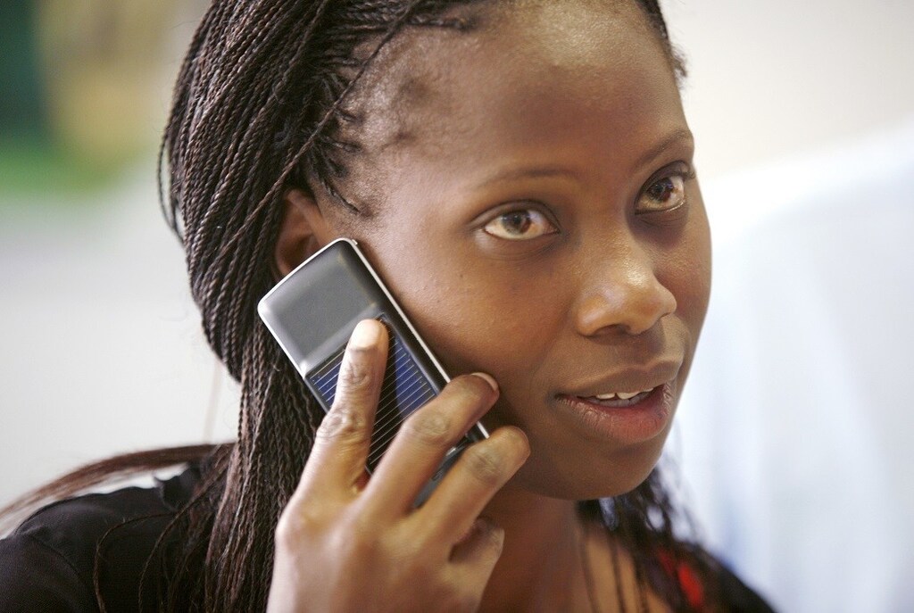 A Safaricom client uses a solar-charged mobile phone handset at a retail centre in Kenya's capital Nairobi, in this September 22, 2009 file photo. Solar cellphones could build on the economic advantages that mobile phones have already brought to far-flung regions of Africa and the Indian subcontinent, including price transparency and more accurate and timely information. Mobile phone penetration in these regions has been held back by a lack of electricity: there is simply no way to charge a cellphone in many rural areas of developing countries. To match feature CELLPHONES-SOLAR/.