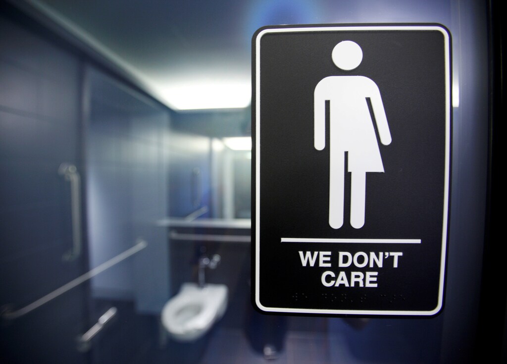 A sign protesting a recent North Carolina law restricting transgender bathroom access adorns the bathroom stalls at the 21C Museum Hotel in Durham, North Carolina May 3, 2016. REUTERS/Jonathan Drake/File Photo - RTX2RU1H