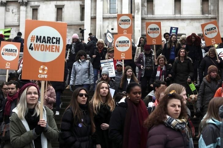 Protestors hold placards as they demonstrate during the March4Women event in central London, Britain, March 4, 2018. REUTERS/Simon Dawson