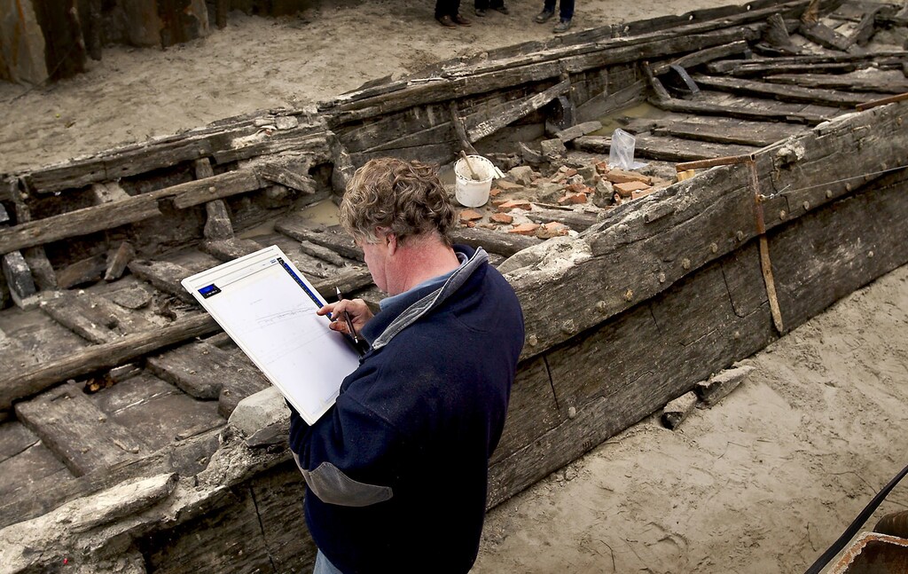 Dutch ship archeologist Jaap Morel sketches the ancient Roman Bargewhich was dug up in the town of Woerden in the centre of theNetherlands October 21, 2003. The barge, dating from around 100 AD, wasdug up in the centre of the Dutch town which was once the location ofthe Roman military settlement Castellum Laurium and a trading outposton the banks of the Rhine. Archaeologists said on Tuesday the ship,equipped with oars, was a unique find that explains how imperial Romedefended itself on its Northern frontiers. REUTERS/Michael KoorenMKN/CRB - RP4DRHYAHFAB