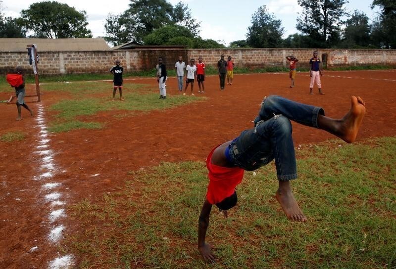Tyron Norman celebrates after scoring a goal at the Ziwani grounds in Nairobi, Kenya May 27, 2018. "This goal is for my beloved mother for allowing me to be a good footballer" Norman said. The eyes of the world will turn to Russia this week for the four-yearly gathering of soccer's superstars but it is away from the glitzy new stadiums built at a staggering cost you must look to find the sport's beating heart; to the dusty streets and poverty-wracked neighbourhoods where the simple act of scoring a goal can still transcend the grind of everyday life. Picture taken may 27, 2018.