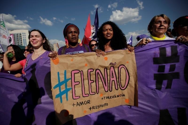 Women holds a sign that reads "Not Him" during demonstrations against presidential candidate Jair Bolsonaro in Brasilia, Brazil September 29, 2018.