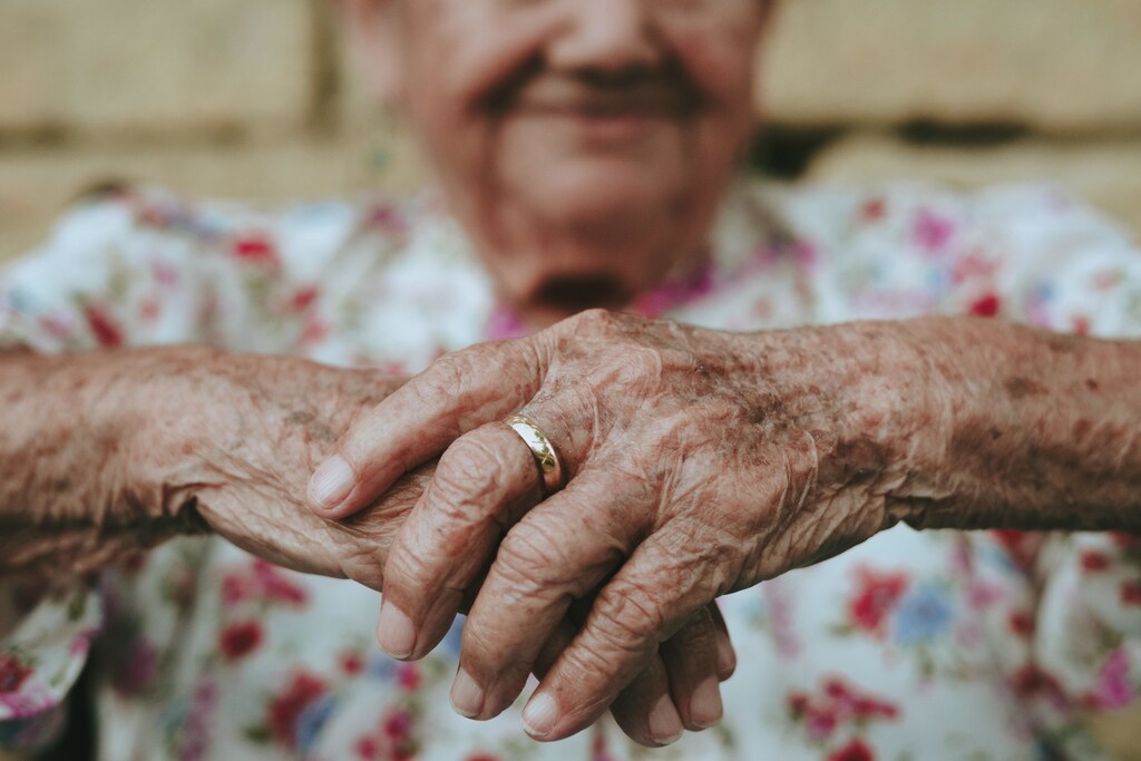 A close-up view of an old person's hands