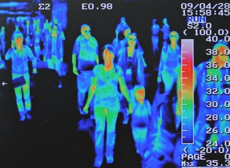 A thermal scanner shows the heat signature of passengers from an international flight arriving at Incheon airport, west of Seoul April 28, 2009. Airlines suffered an 11.1 percent fall in passenger numbers in March year-on-year, and swine flu stands to compound financial problems and suppress traffic even more, an industry body said on Tuesday. REUTERS/Jung Yeon-je (SOUTH KOREA HEALTH TRANSPORT TRAVEL IMAGES OF THE DAY) - GM1E54S1AST01