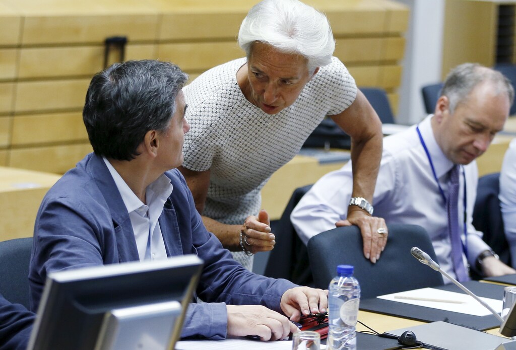 Greek Finance Minister Euclid Tsakalotos listens to International Monetary Fund (IMF) Managing Director Christine Lagarde (C) during an euro zone finance ministers meeting in Brussels, Belgium, July 11, 2015. Skeptical European finance ministers gathered on Saturday to decide whether to negotiate a third bailout for Greece after Prime Minister Alexis Tsipras won lawmakers' backing for painful austerity measures his leftist party was elected to prevent. REUTERS/Francois Lenoir? TPX IMAGES OF THE DAY - RTX1JZT3