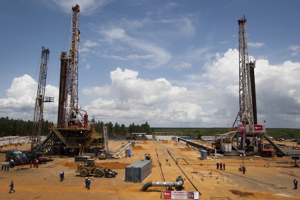 Employees work on drilling rigs at an oil well operated by Venezuela's state oil company PDVSA in Morichal July 28, 2011. Venezuela received an enviable honor last month: OPEC said it is sitting on the biggest reserves of crude oil in the world -- even more than Saudi Arabia. But the Venezuelan oil industry is also sitting atop a well of trouble. Picture taken on July 28, 2011. To match Special Report VENEZUELA/PDVSA