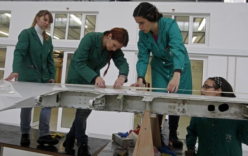 Pupils work on the wing of a plane at a classroom of aeronautics in the Instituto do Emprego e Formacao Profissional (IEFP) vocational training center in Setubal February 1, 2013. For Portugal to succeed in ambitions to reindustrialise its shrinking, debt-laden economy, it will not be down to the revival of mass manufacturing but to the sprouting of high-tech start-ups such as UAVision. As the name Unmanned Aerial Vehicles suggests, drones mounted with cameras are a mainstay for the small engineering firm. Clients include big farmers who want to monitor conditions in their fields. One drone has been adapted to film camel racing in Dubai. Picture taken February 1, 2013. To match Analysis PORTUGAL-ECONOMY/INDUSTRY REUTERS/Jose Manuel Ribeiro (PORTUGAL - Tags: TRANSPORT EDUCATION BUSINESS INDUSTRIAL) - GM1E9411SAK01