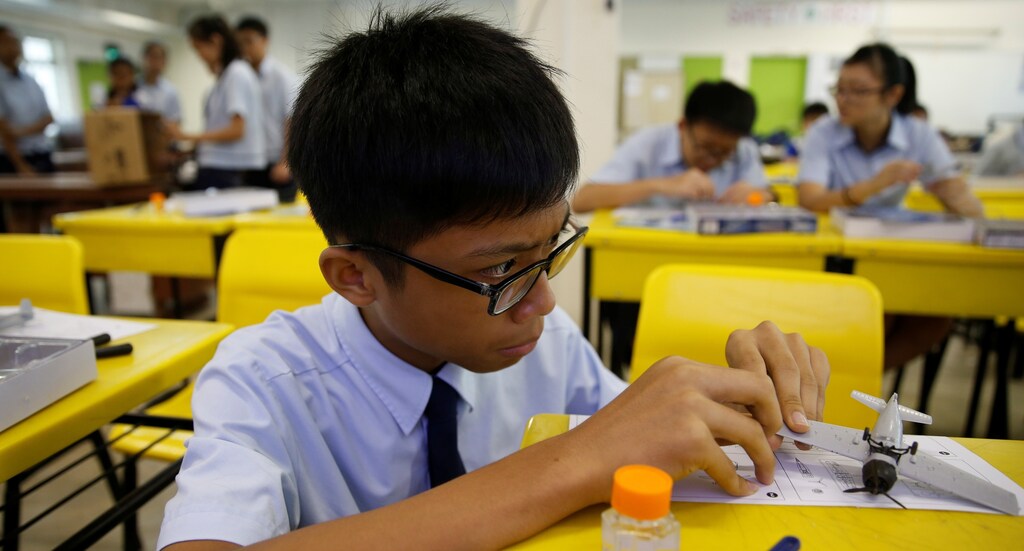 A student assembles a model aeroplane during an enrichment class at a secondary school in Singapore October 27, 2016.