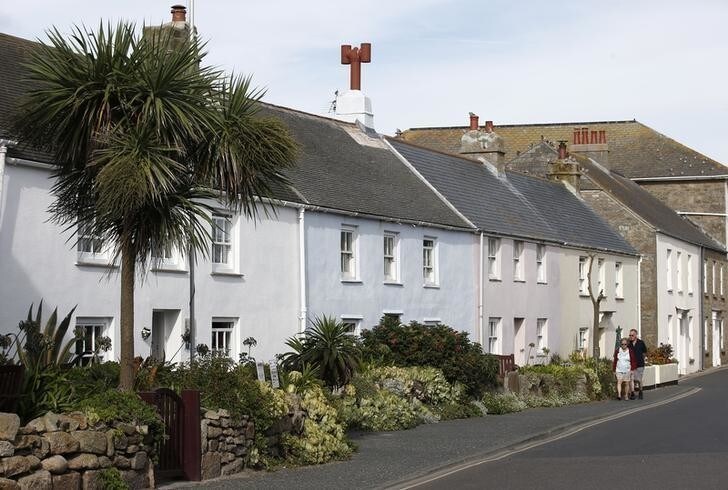 People walk past cottages in the centre of Hugh Town on the Scilly isle of St. Mary's, Britain September 1, 2016. REUTERS/Peter Nicholls