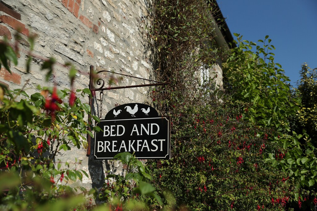 A bed and breakfast sign is seen at the Alford House in Corfe Castle, Britain, July 21, 2018. REUTERS/Peter Cziborra