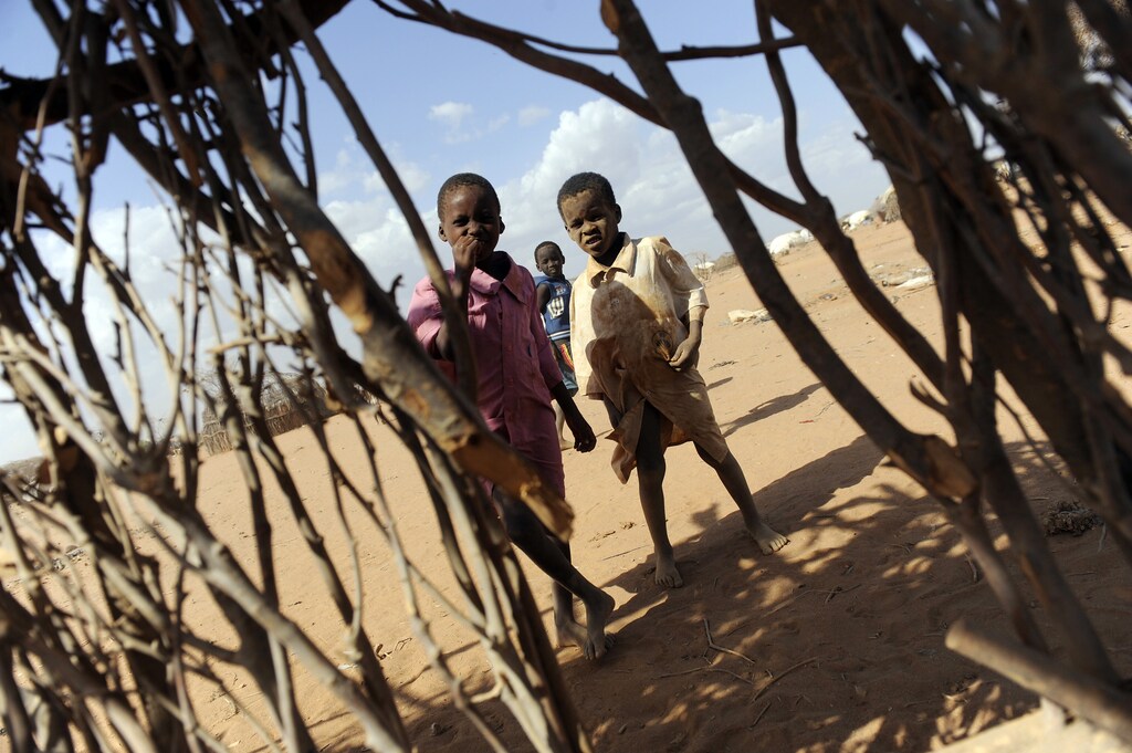 Children play outside the shell of a makeshift home, or "tukul", in the outskirts of Dagahaley settlement at Kenya's Dadaab Refugee Camp, situated northeast of the capital Nairobi, near the Somali border, August 31, 2011.