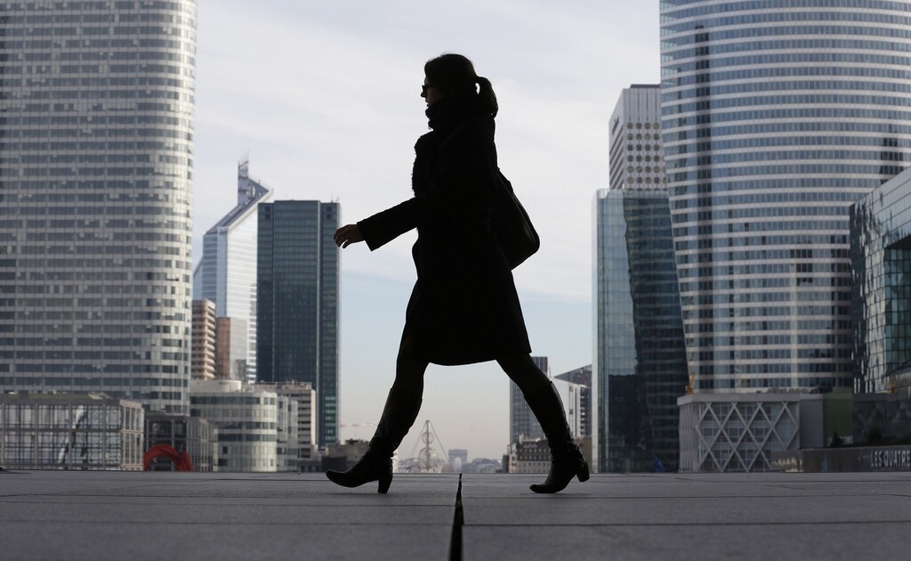 A Businesswoman is silhouetted as she makes her way under the Arche de la Defense, in the financial district west of Paris, November 20, 2012. France said its economy was sound and reforms were on track after credit ratings agency Moody's stripped it of the prized triple-A badge due to an uncertain fiscal and economic outlook. Monday's downgrade, which follows a cut by Standard & Poor's in January, was expected but is a blow to Socialist President Francois Hollande as he tries to fix France's finances and revive the euro zone's second largest economy. REUTERS/Christian Hartmann (FRANCE - Tags: POLITICS BUSINESS) - RTR3ANMB
