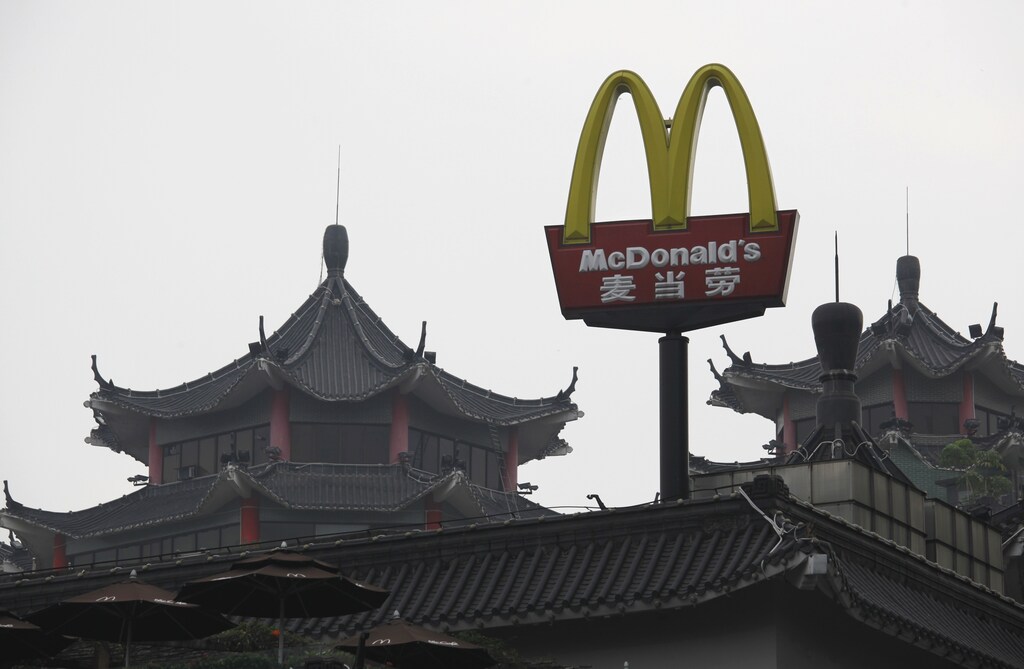 A McDonald's sign is displayed outside its outlet, the first one which opened in China in 1990, at the southern Chinese city of Shenzhen neighbouring Hong Kong March 18, 2013. McDonald's Corp gave away more than a million breakfast McMuffins across China on Monday, a few days after Chinese state television aired its annual expose on corporate malpractice to mark World Consumer Rights Day. The promotion, the U.S. fast food chain says, was purely coincidental. REUTERS/Bobby Yip (CHINA - Tags: FOOD BUSINESS LOGO POLITICS SOCIETY) - RTR3F51T