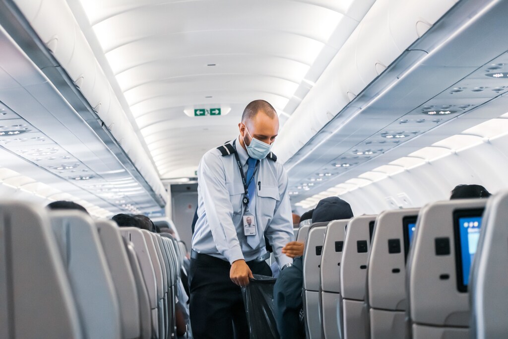 Airline cabin crew wearing a face mask.