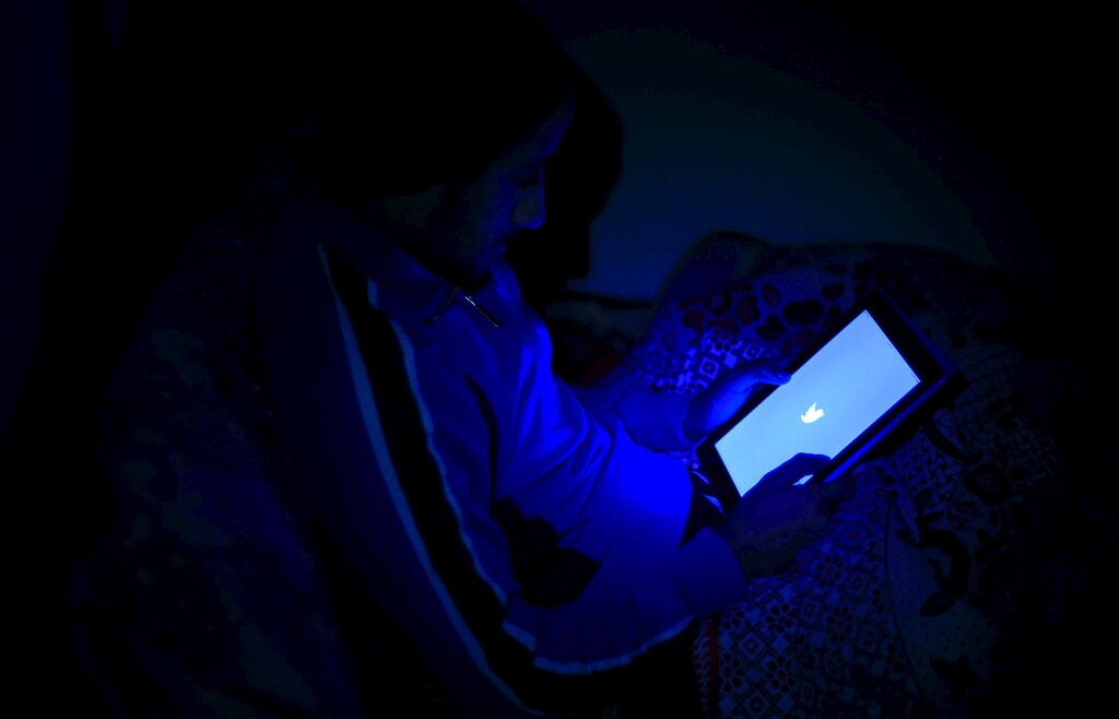 A youth launches Twitter social media application on a tablet in Cairo, Egypt, January 24, 2016. In 2011, activist Esraa Abdel-Fattah helped ignite revolution on the streets of Egypt and was nominated for a Nobel Peace Prize. Five years after the fall of autocrat Hosni Mubarak, she is shunned or insulted by Egyptians on those same streets. Picture take January 24, 2016. REUTERS/Stringer - RTX23W6U