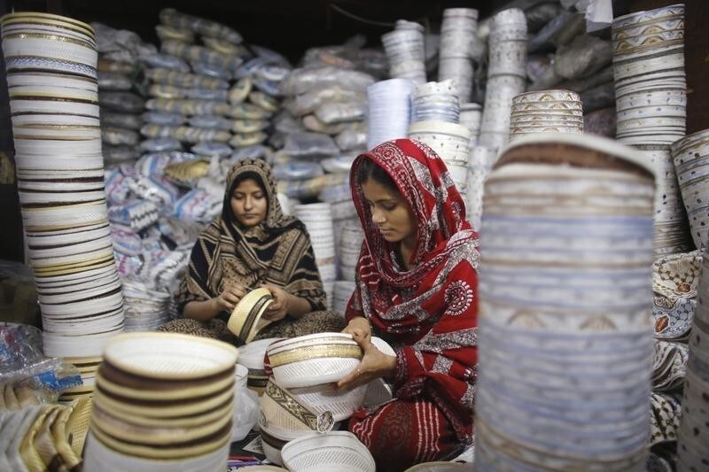 Workers sew prayer caps, which are high in demand during the holy fasting month of Ramadan, at a factory in old Dhaka July 10, 2014. REUTERS/Andrew Biraj (BANGLADESH - Tags: RELIGION BUSINESS SOCIETY TPX IMAGES OF THE DAY) - GM1EA7A1NN101