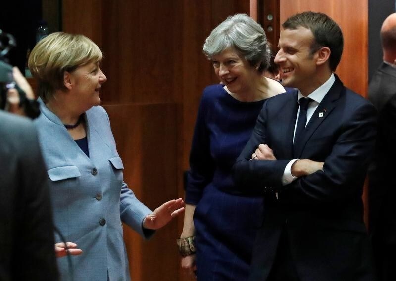 German Chancellor Angela Merkel (L) British Prime Minister Theresa May (C) and French President Emmanuel Macron arrive at the EU summit in Brussels, Belgium October 19, 2017. REUTERS/Yves Herman - RC11D7FEBD10