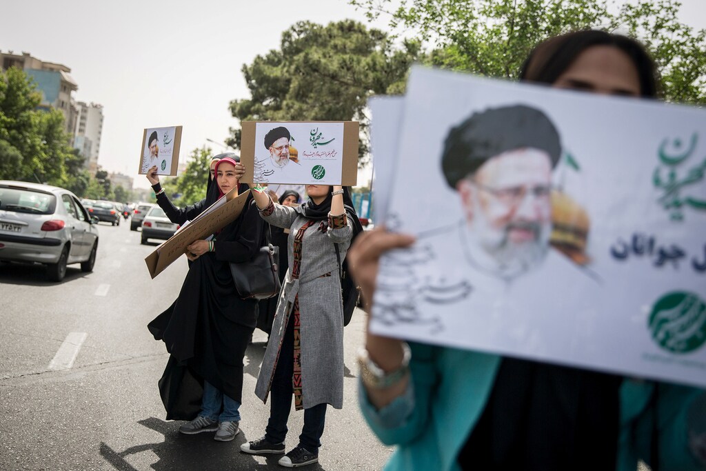 Supporters of Iranian Presidential candidate Ebrahim Raisi hold his posters outside the Mosalla mosque in Tehran, Iran, May 16, 2017. REUTERS/TIMA ATTENTION EDITORS - THIS IMAGE WAS PROVIDED BY A THIRD PARTY. FOR EDITORIAL USE ONLY. - RTX363Q8