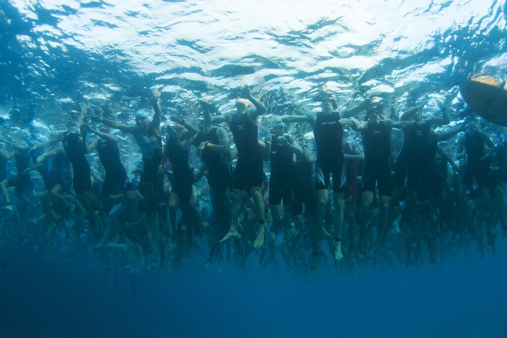 Amateur triathletes wait for the start of the 2.4 miles (3.86 km) swim portion during the Ironman World Championship in Kailua-Kona, Hawaii, October 12, 2013.