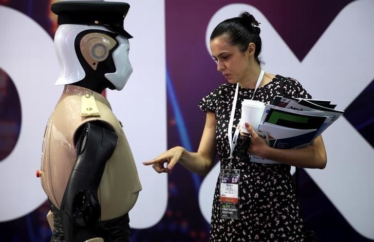 A visitor looks at an operational robot policeman at the opening of the 4th Gulf Information Security Expo and Conference (GISEC) in Dubai, United Arab Emirates, May 22, 2017. REUTERS/Stringer