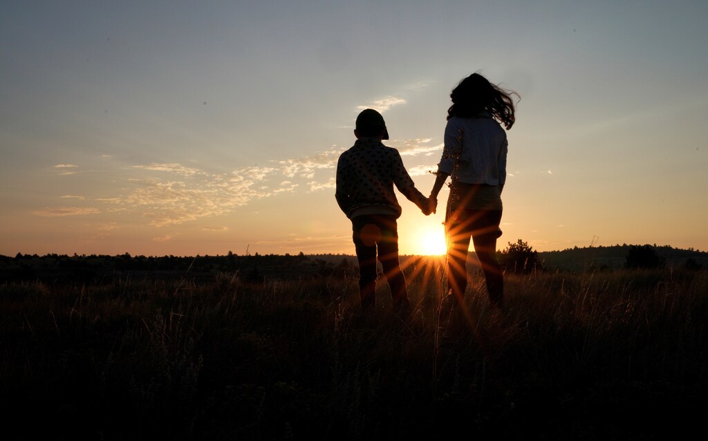 Lauren Coria-Avila and her daughter Sielh Avila watch the sunrise as they wait for the solar eclipse in Guernsey, Wyoming, U.S. August 21, 2017