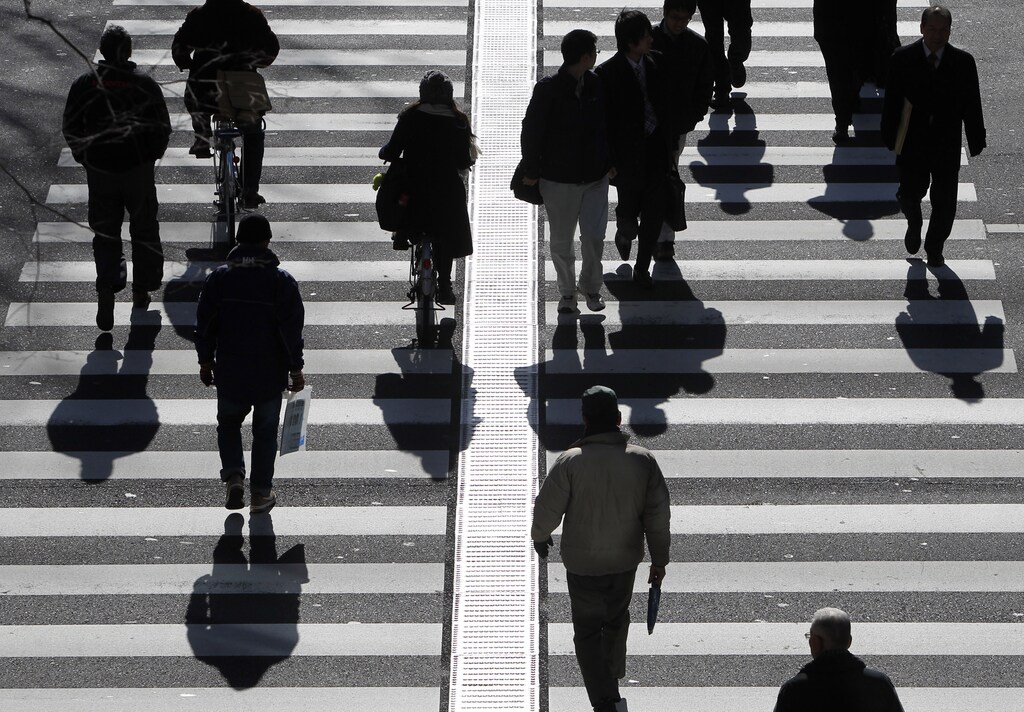 People walk on a crosswalk in Tokyo January 11, 2011. AI has added 1.3 million jobs.