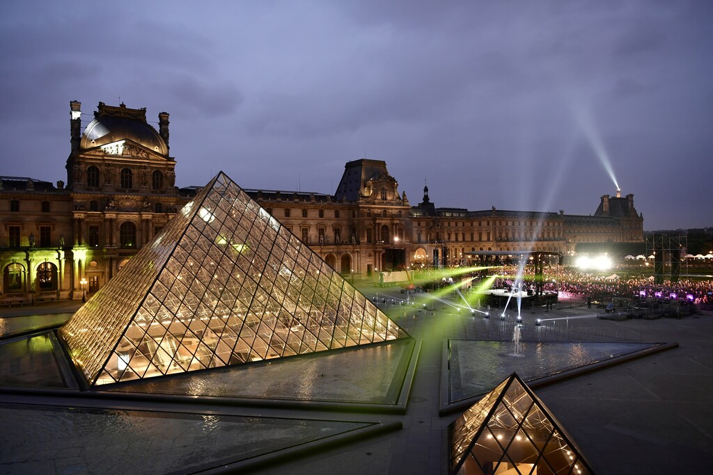Supporters of French President-Elect, Emmanuel Macron gather to celebrate at the Pyramid du Louvre following the announcement of the results in the second round of the French presidential election, in Paris, France, May 7, 2017. REUTERS/Philippe Lopez/Pool - RC14915F8870