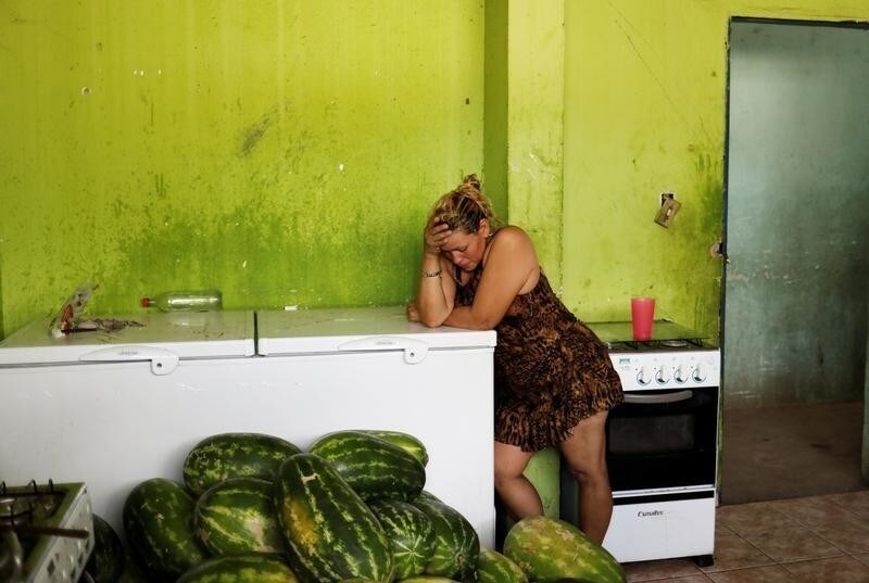 A Venezuelan woman stands in a kitchen of a gym which has turned into a shelter for Venezuelans and is run by Civil Defense with meals provided by Evangelical churches in Caimbe neighbourhood in Boa Vista, Roraima state, Brazil November 17, 2017. REUTERS/Nacho Doce SEARCH "VENEZUELAN MIGRANTS" FOR THIS STORY. SEARCH "WIDER IMAGE" FOR ALL STORIES. TPX IMAGES OF THE DAY - RC164D04B160