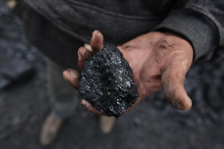 A miner holds a piece of coal outside an unregulated coal mine in Sabinas January 15, 2013. Everyday, thousands of miners go to work in the unregulated coals mines of northern Mexico knowing they may not return. Facing death on a daily basis has become a fact of life for these men as they struggle to scrape out a living in an environment bereft of rules and regulations, lacking even the most basic equipment. Unregulated mines are legal in Mexico. A company buys or leases land from a cooperative and is legally allowed to mine on it, but is not subject to any regulations. Despite the dangers, some 30,000 miners find themselves willing to take the risk, approaching their job with a matter-of-fact philosophy. Picture taken January 15, 2013. REUTERS/Daniel Becerril (MEXICO - Tags: ENERGY BUSINESS EMPLOYMENT COMMODITIES)