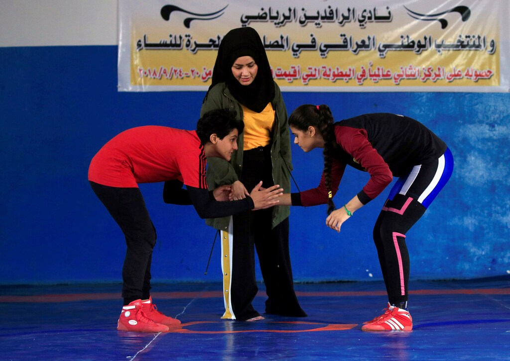 Iraqi women, part of the country's first women's wrestling squad, face each other during practice at the sports club in Diwaniya, Iraq November 10, 2018. Picture taken November 10, 2018. REUTERS/Alaa Al-Marjani - RC1EB292CE40