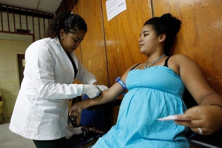 A nurse extracts blood from a pregnant woman as part of a general routine check, which includes examination for mosquito-borne viruses like Zika, at the maternity ward of the Hospital Escuela in Tegucigalpa, Honduras, April 15, 2016