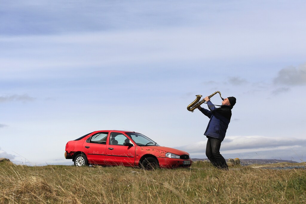 Artist and poet Barry Edgar Pilcher, age 69, poses for a photograph as he plays the saxophone on the Island of Inishfree in County Donegal May 1, 2012. Pilcher is the only inhabitant of the island on which he has lived for the past 20 years. He only leaves the island once a week to collect his pension and buy groceries on the mainland. REUTERS/Cathal McNaughton (IRELAND - Tags: ENTERTAINMENT SOCIETY) - LM1E8520USK01