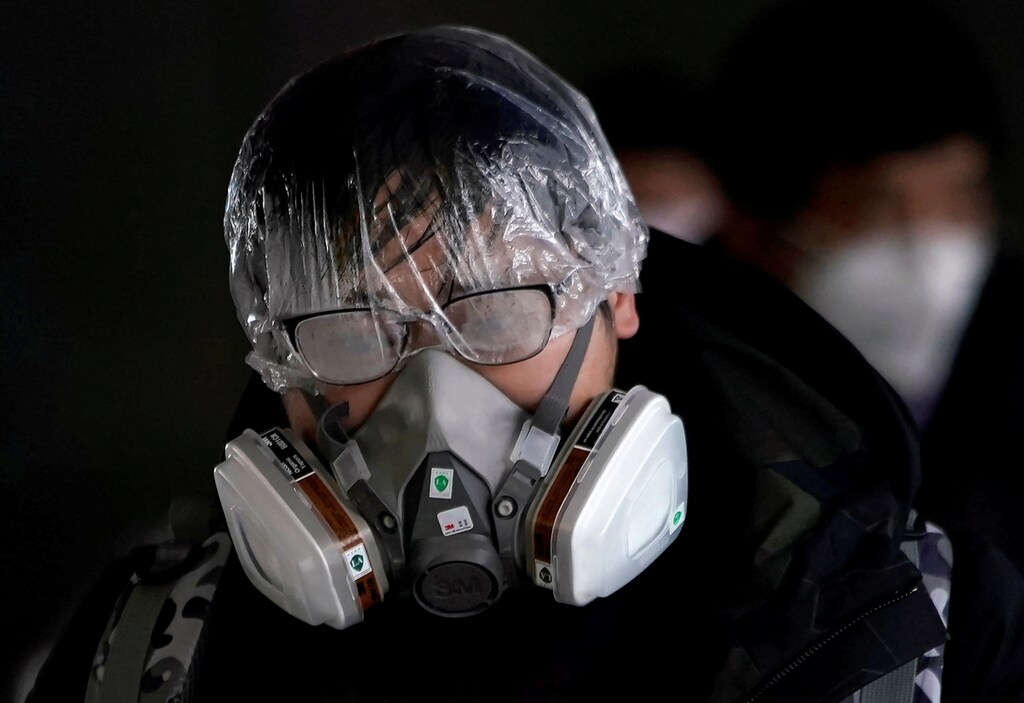 A passenger wearing a mask walks outside the Shanghai railway station in Shanghai, China, as the country is hit by an outbreak of the novel coronavirus, February 8, 2020. REUTERS/Aly Song TPX IMAGES OF THE DAY - RC2AWE9X1AHR