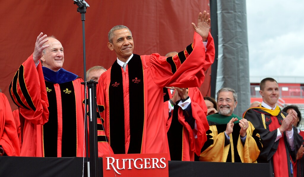 U.S. President Barack Obama acknowledges the applause as he is escorted by Rutgers President Robert Barchi at High Point Solutions Stadium during Rutgers University's 250th commencement exercises, in New Brunswick, New Jersey, May 15, 2016.