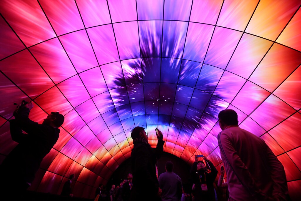 Attendees view video on a tunnel of LG OLED televisions during the 2017 CES in Las Vegas, Nevada, U.S., January 5, 2017. REUTERS/Steve Marcus - RTX2XOOX