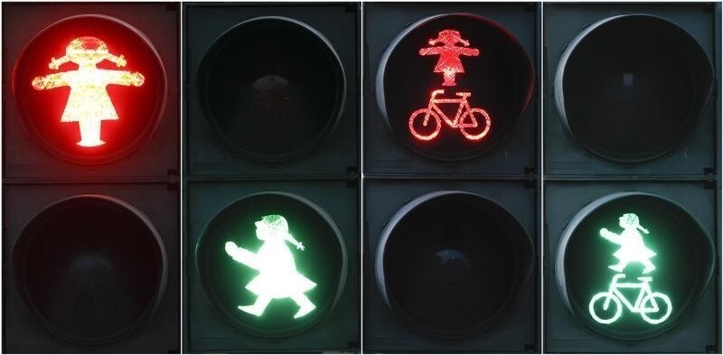 A combination of four pictures show red and green crossing signals for pedestrian and cyclists featuring a woman in the east German town of Fuerstenwalde, south east of Berlin March 7, 2012. The pig-tailed female crossing guard has ousted her traditional, hat-wearing male counterpart inFuerstenwalde in time for International Women's Day on Thursday. REUTERS/Fabrizio Bensch (GERMANY - Tags: SOCIETY TRANSPORT) - RTR2Z05C