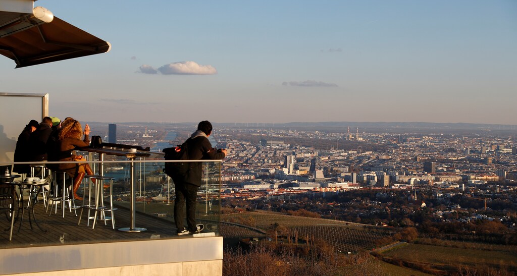 Tourists enjoy a sunny day on mount Kahlenberg in Vienna, Austria March 12, 2019. Picture taken March 12, 2019. REUTERS/Leonhard Foeger - RC130100FEB0