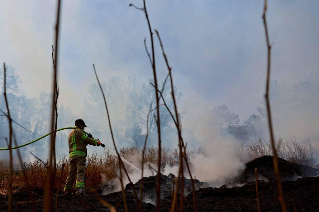 A firefighter works near Latrun, a day after wildfires broke out due to extreme heat and winds, in central Israel.
