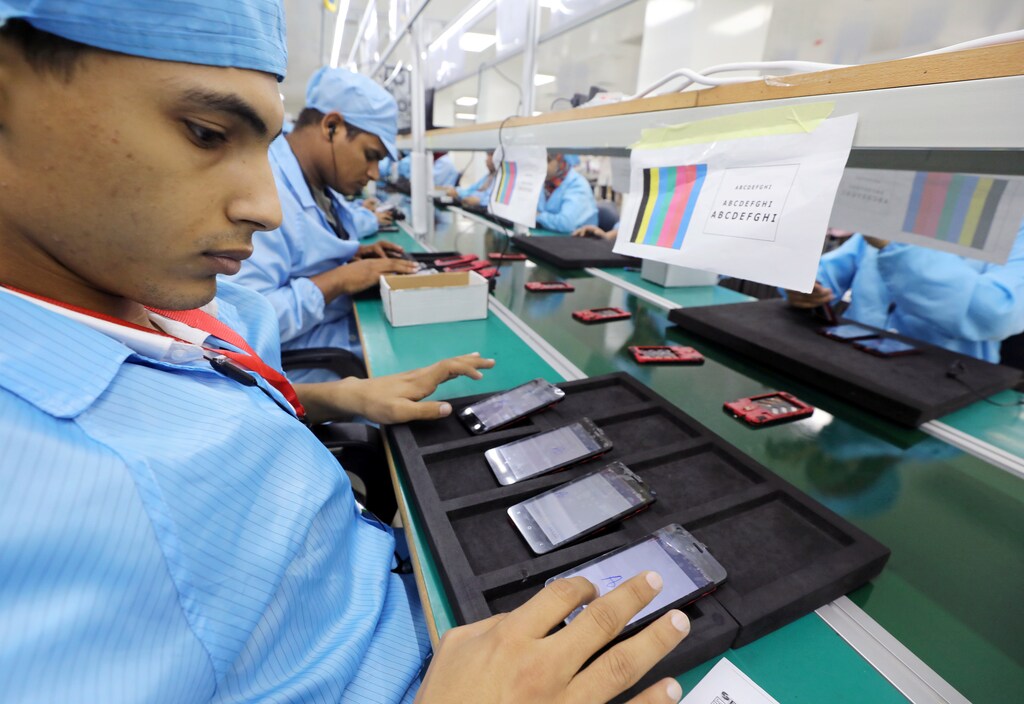 Egyptians working at a mobile-phone factory.