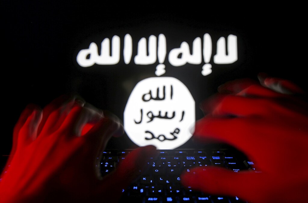 A man types on a keyboard in front of a computer screen on which an Islamic State flag is displayed, in this picture illustration taken in Zenica, Bosnia and Herzegovina, February 6, 2016. Twitter Inc has shut down more than 125,000 terrorism-related accounts since the middle of 2015, most of them linked to the Islamic State group, the company said in a blog post on Friday. REUTERS/Dado Ruvic - GF10000297962