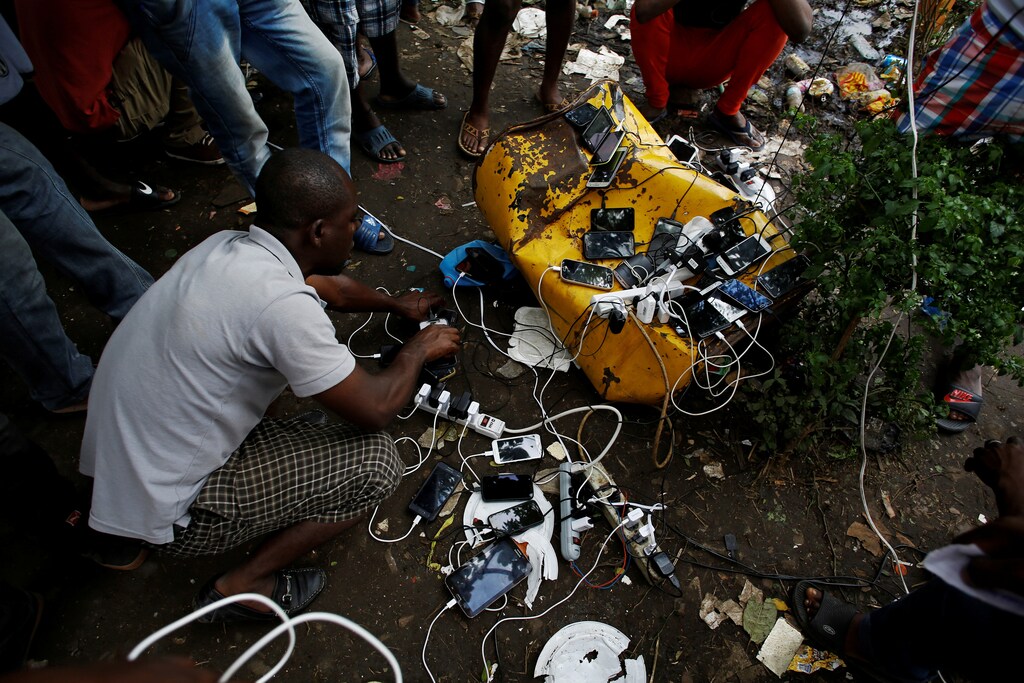 African migrants stranded in Costa Rica charge their phones at a makeshift camp at the border between Costa Rica and Nicaragua, in Penas Blancas, Costa Rica July 15, 2016