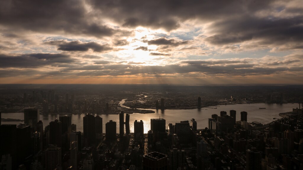 The sun peaks through the clouds above the East River as seen from the Empire State Building in New York City, U.S., February 14, 2019