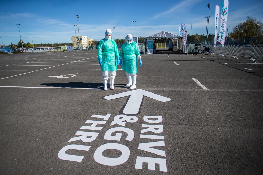 Medical workers stand next to the drive-through mobile testing side for the coronavirus disease (COVID-19) in Bydgoszcz , Poland April 23, 2020.