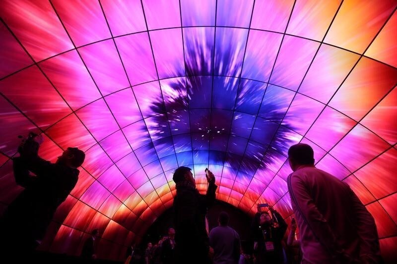 Attendees view video on a tunnel of LG OLED televisions during the 2017 CES in Las Vegas, Nevada, U.S., January 5, 2017. REUTERS/Steve Marcus