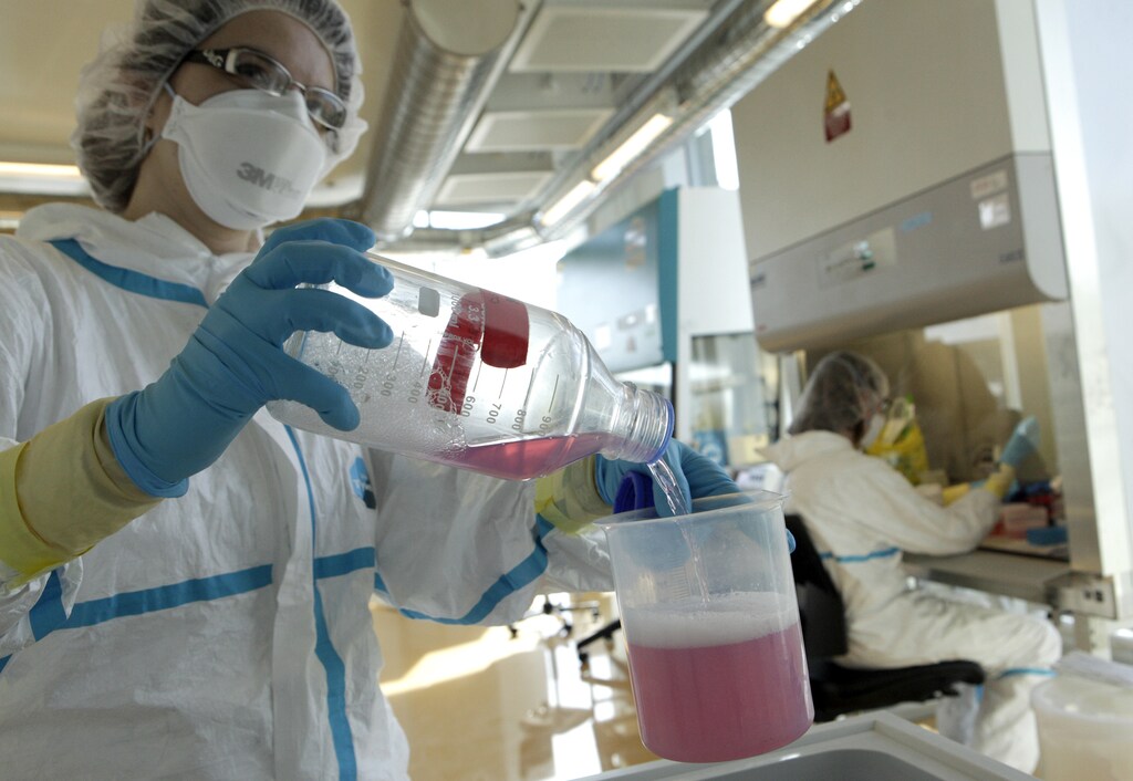A lab assistant performs an experiment during an inauguration visit of a new P3 level research laboratory against tuberculosis at the School of Life Sciences of the Swiss Federal Institute of Technology (EPFL) in Lausanne in Ecublens near Lausanne March 17, 2010. Financed by the Stavros Niarchos Foundation and the Swiss Government, the lab is open to researchers from EPFL and nearby universities in order to study in vivo strains of Bacillus anthracis, the air-borne pathogen causing tuberculosis. There are around 500 cases of tuberculosis each year in Switzerland alone. REUTERS/Denis Balibouse (SWITZERLAND - Tags: HEALTH SCI TECH) - BM2E63H19U801