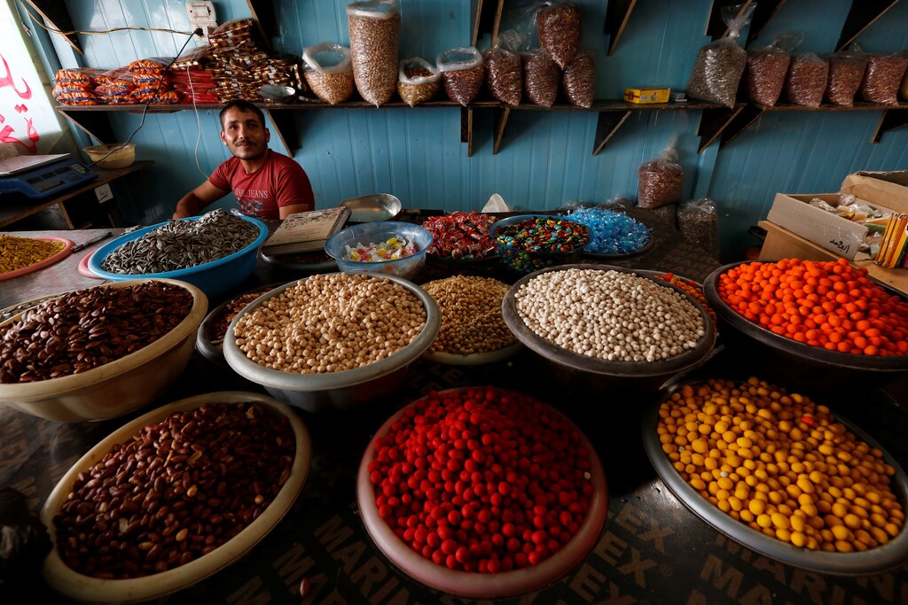 A man works at a sweet shop at the main market in Al Zaatari refugee camp outside the city of Mafraq in Jordan, near the border with Syria, July 17, 2017. Picture taken July 17, 2017. REUTERS/Darrin Zammit Lupi - RC13BA636B30