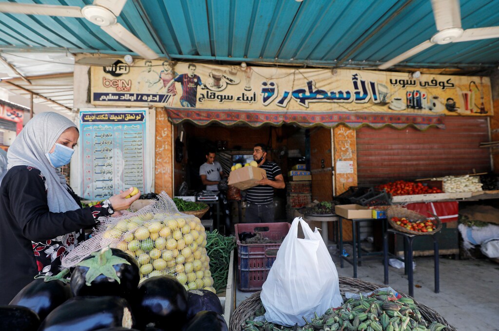 A woman buys vegetables from a cafe transformed into a fruit and vegetable shop, as cafes have been closed following the outbreak of the coronavirus disease (COVID-19), in Cairo, Egypt June 2, 2020. Picture taken June 2, 2020. REUTERS/Mohamed Abd El Ghany - RC245H9D5UO8