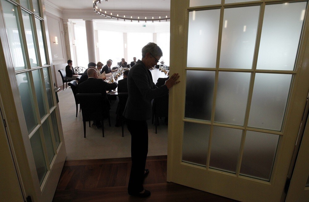 A clerk closes the door before a round table talk on the shifting of lower import prices to customers due to the strong Swiss franc in Bern August 10, 2011.